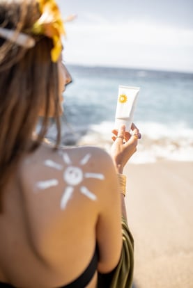 woman-with-sunscreen-lotion-on-the-beach-2023-11-27-05-33-45-utc-1